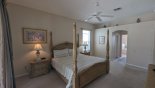 Master bedroom #1 viewed towards ensuite bathroom - LCD cable TV just out of view - www.iwantavilla.com is the best in Orlando vacation Villa rentals