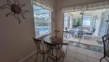 Breakfast nook with table & 4 chairs with views and access to pool deck from Monterey 1 Villa for rent in Orlando