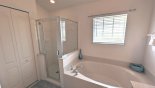 Master ensuite #1 showing bath & shower with this Orlando Villa for rent direct from owner