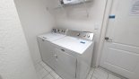 Laundry room with washer, dryer, iron & ironing board - www.iwantavilla.com is your first choice of Villa rentals in Orlando direct with owner