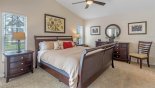 Master bedroom with king sized bed and views onto pool deck - www.iwantavilla.com is the best in Orlando vacation Villa rentals