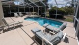 Villa rentals in Orlando, check out the View of pool deck showing high hedge to left side mirrored on other side too