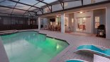 Villa rentals in Orlando, check out the View of pool & spa towards covered lanai at twilight