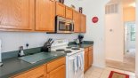 Galley kitchen arch leads to bedrooms 2, 3 & 4 as well as laundry room & family bathroom from Springtree 2 Villa for rent in Orlando