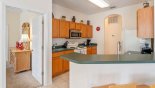 Villa rentals near Disney direct with owner, check out the Kitchen breakfast bar with 2 bar stools - door to left leads to master bedroom