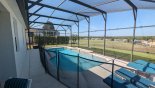 Spacious rental Highlands Reserve Villa in Orlando complete with stunning Pool deck showing removable pool safety fence erected