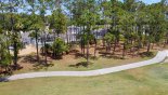 View of villa through trees from golf course from Newton 1 Villa for rent in Orlando