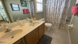Master ensuite bathroom #6 with bath & shower over, his & hers vanities and WC - www.iwantavilla.com is the best in Orlando vacation Villa rentals