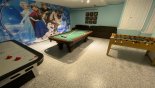 Games room with Frozen-theming incorporating a pool table, air hockey, Foosball & TV - www.iwantavilla.com is the best in Orlando vacation Villa rentals