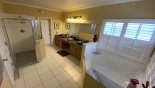 Master #1 ensuite bathroom with large bath, walk-in shower, his & hers sinks & WC - www.iwantavilla.com is the best in Orlando vacation Villa rentals