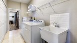 Villa rentals in Orlando, check out the Laundry room leading to games room with washer, dryer, iron & ironing board