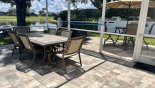 Spacious rental Formosa Gardens Villa in Orlando complete with stunning View of alfresco dining area inside and outside pool cage