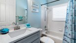 Family bathroom #3 with bath & shower over, single vanity & WC with this Orlando Villa for rent direct from owner