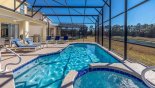 View of pool & spa showing pond view and woodland beyond - www.iwantavilla.com is the best in Orlando vacation Villa rentals