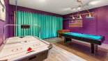 Games room with AC, pool table, air hockey & table foosball - www.iwantavilla.com is the best in Orlando vacation Villa rentals