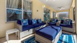 Covered lanai with comfortable seating to relax and watch the kids enjoying themselves on the pool with this Orlando Villa for rent direct from owner