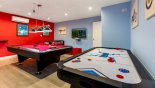 Air conditioned games room, with pool table, table foosball, air hockey, and large TV with Xbox One - www.iwantavilla.com is the best in Orlando vacation Villa rentals