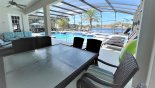 View of pool deck and lake beyond from patio table - what a view !! with this Orlando Villa for rent direct from owner