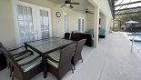 Covered lanai with patio table & 6 comfortable chairs with this Orlando Villa for rent direct from owner