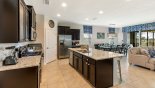 View of kitchen towards dining area with this Orlando Villa for rent direct from owner
