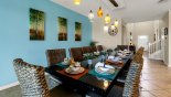 Dining area with long table & 12 chairs - views towards entrance foyer from Windsor at Westside rental Villa direct from owner