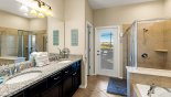 Master ensuite bathroom #1 with bath, walk-in shower & his 'n' hers sinks, separate WC - access onto pool deck with this Orlando Villa for rent direct from owner