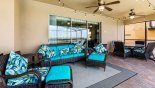 Villa rentals in Orlando, check out the Covered lanai with soft seating area and outdoor dining space