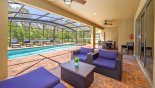 Covered lanai with patio table with 6 chairs and soft seating area from Baymont 2 Villa for rent in Orlando