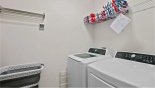 Laundry room with washer, dryer, iron & ironing board with this Orlando Villa for rent direct from owner