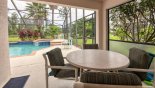 Covered lanai with round patio table and 4 chairs - another 4 chairs available on pool deck from Belmonte + 5 Villa for rent in Orlando