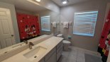 Family bathroom #3 with bath & shower over, single vanity & WC with this Orlando Villa for rent direct from owner