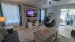 Family room with views & access onto pool deck - www.iwantavilla.com is your first choice of Villa rentals in Orlando direct with owner