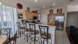 Breakfast bar with 4 bar stools adjacent to breakfast nook from Huntington 1 Villa for rent in Orlando