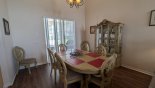 Dining area with dining table & 6/8 chairs - sliding door access to pool deck - www.iwantavilla.com is the best in Orlando vacation Villa rentals